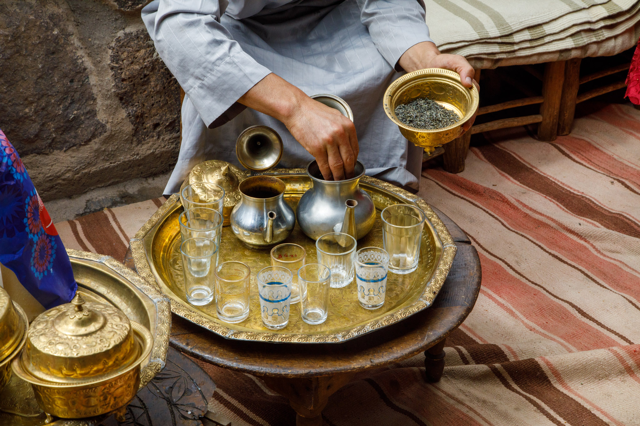 Traditional Moroccan mint tea service with family in atlas mountain
