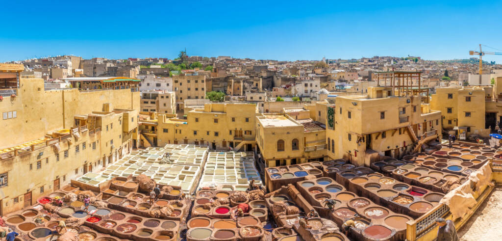 Guided tour of Fès tanneries with vibrant dyeing vats and traditional leather craftsmanship – immersive cultural experience with Morocco Luxury Highlights