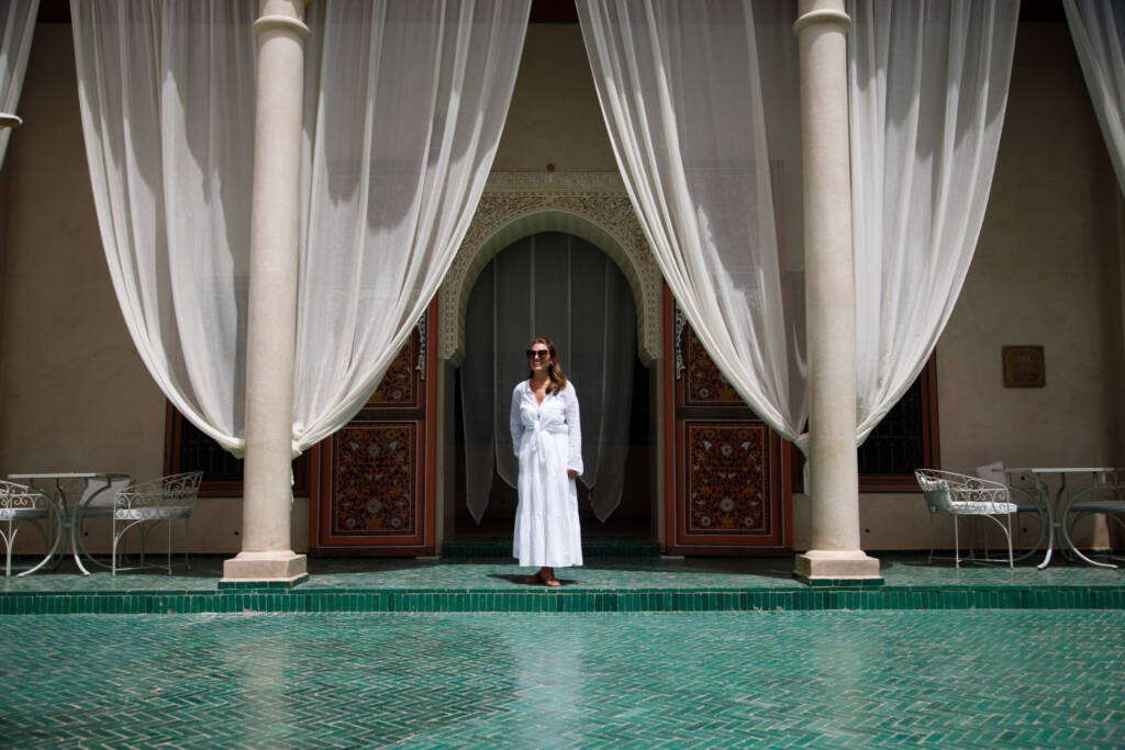 Private luxury guide giving an exclusive tour of the Medersa Ben Youssef in Marrakech, highlighting its architecture and history.