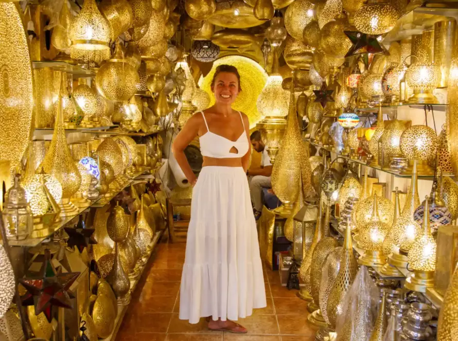 Client exploring a boutique of handmade lamps in Marrakech, experiencing Morocco’s artisanal craftsmanship with Morocco Luxury Highlights.