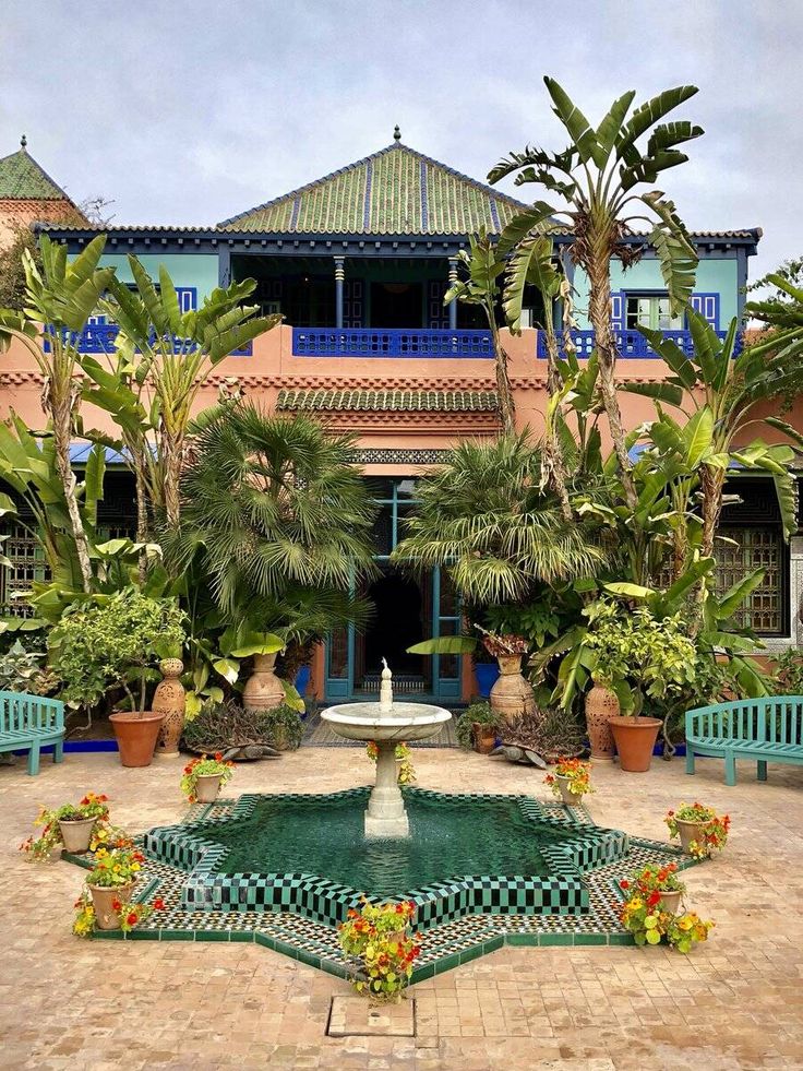 Private garden of Villa Oasis in Marrakech, part of the iconic villa saved by Pierre Bergé and Yves Saint Laurent, surrounded by lush greenery and traditional Moroccan architecture.