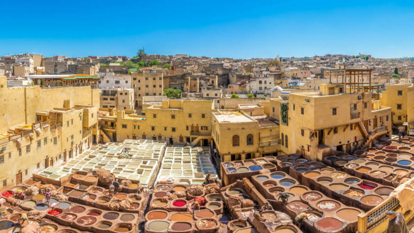 Traditional leather craftsmanship in the Fes tanneries, showcasing what to buy in Morocco through authentic handmade leather goods