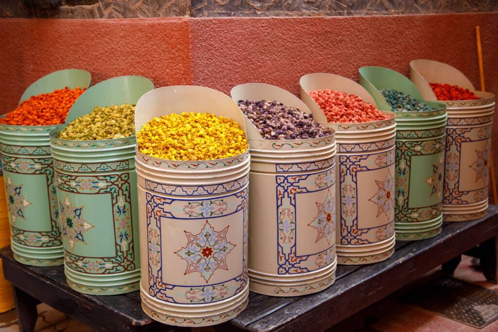 Colorful Moroccan spices in the Marrakech medina souk, highlighting what to buy in Morocco such as saffron and traditional spice blends