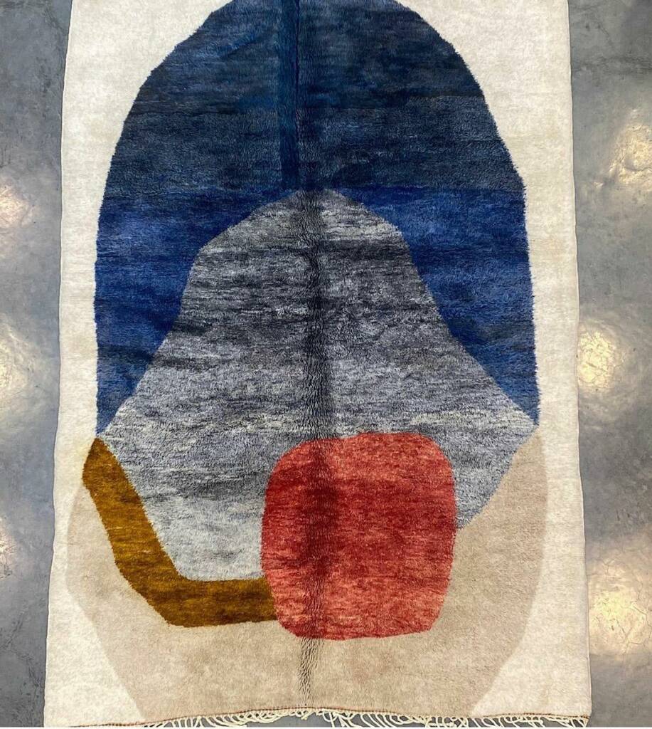 Personal shopper assisting in choosing handcrafted Moroccan rugs in Marrakech medina, bespoke carpet experience